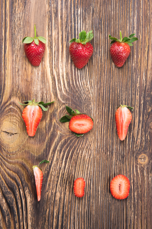 half red strawberries beautifully put on burnt plankの写真素材