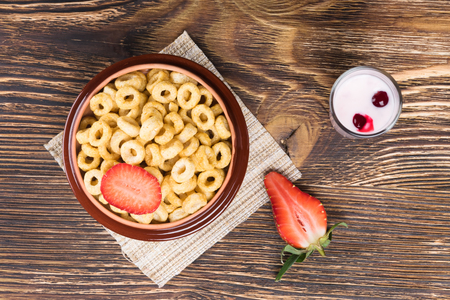 Breakfast with corn rings and yogurt with strawberriesの写真素材