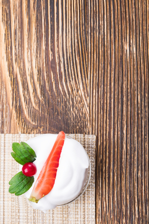 piece of strawberry in cream on a table in the cornerの写真素材