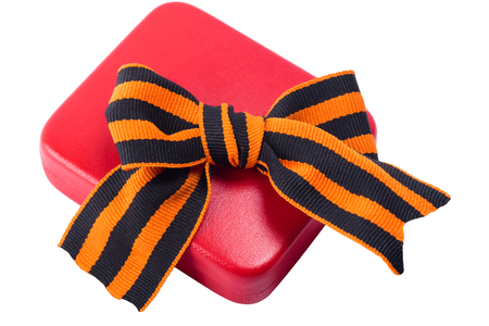 Red case for the award on the ninth of May and a bow on it, on a white backgroundの写真素材