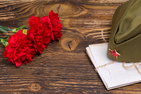 Military letters under the cap and three carnations in honor of May 9の写真素材