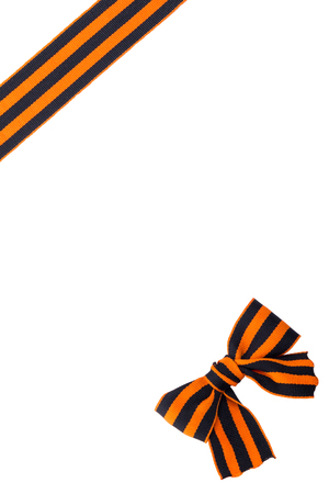 Knot in front of black orange ribbon on white backgroundの写真素材