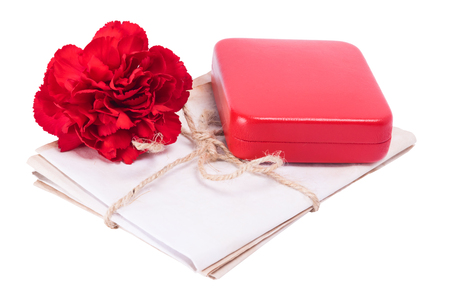 Red carnation with award on old documents, on white backgroundの写真素材