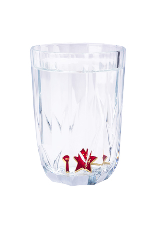 Red victory star at the bottom of a faceted glass isolated on a white backgroundの写真素材