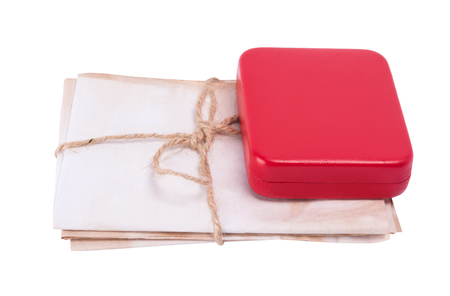 Old letters tied with a rope lying under the box, isolated on white backgroundの写真素材