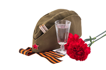 Military cap with red flowers and a star, concept, isolated on whiteの写真素材