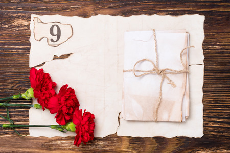 beautiful greeting card on may 9, the red flowers on the table on old paperの写真素材