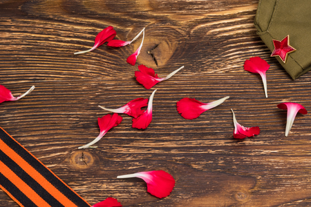 Concept from the petals of a red carnation, on an old wooden tableの写真素材