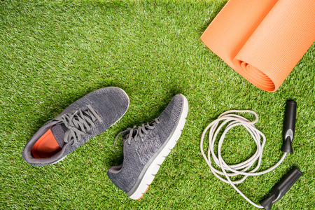 running shoes and skipping rope for training , on a grass backgroundの写真素材