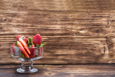 beautiful cup with strawberries on a dark tableの写真素材