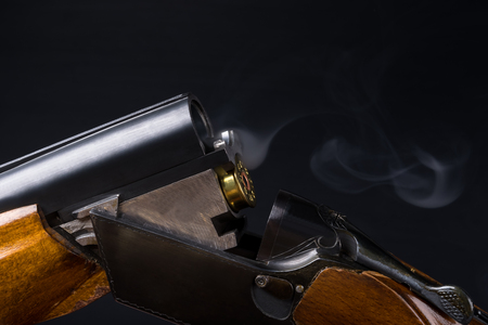 the smoke after firing a shotgun on a black backgroundの写真素材