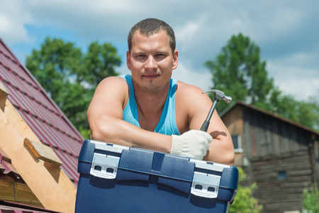 the man on the roof on the box with the toolの写真素材