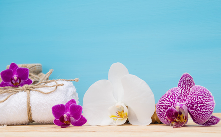 White towel and white orchid on a blue backgroundの写真素材