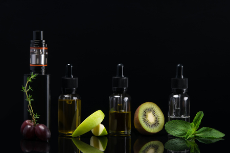 set of flavors for e cigarette on black background with reflectionの写真素材