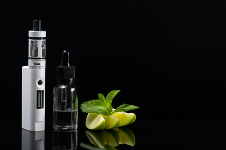 Mint apple taste for an electronic cigarette with reflection on a black backgroundの写真素材