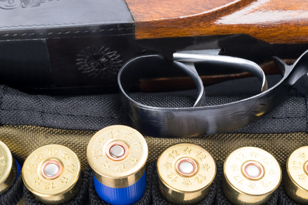 Trigger from a hunting rifle next to cartridgesの写真素材