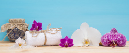 White towel with the smell of orchids on the tableの写真素材