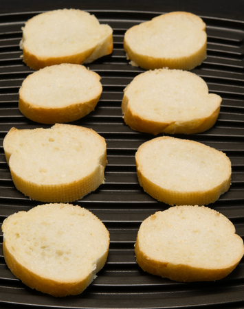 bread is cut into eight pieces and decomposed on a black backgroundの写真素材