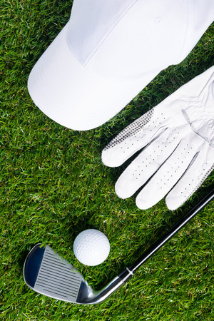 Set for playing golf lies on a green lawnの写真素材