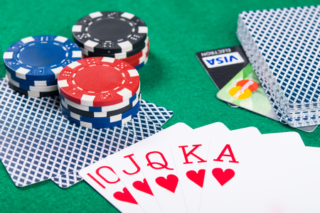Poker game on money on a credit card, concept on a green poker tableの写真素材