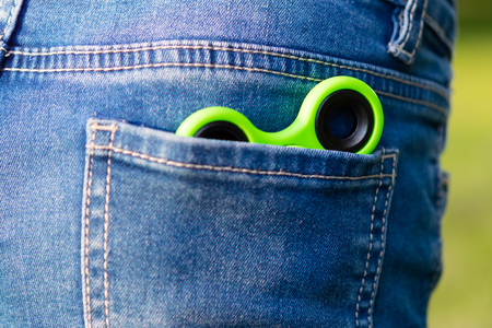 Green spinner in the child's jeans pocket, for playing with friends on the streetの写真素材