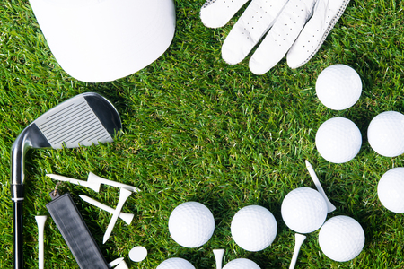 On a green lawn for a background lined with golf equipment, there is a place for an inscriptionの写真素材