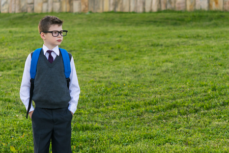 Schoolboy with a backpack looking at the place for your inscriptionの写真素材