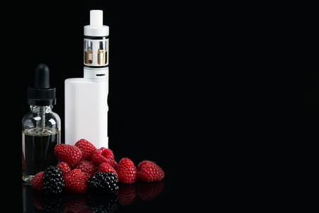 electronic cigarette with dressing for her, with raspberry flavor on a black background, with a hatchingの写真素材