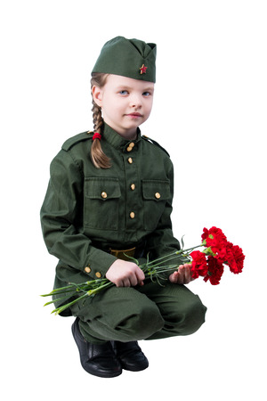 baby girl sitting in uniform with red flowers, on white backgroundの写真素材