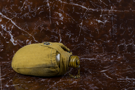 on a marble monument a military water tank a green jarの写真素材