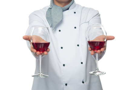 cook, holds two glasses of red wineの写真素材