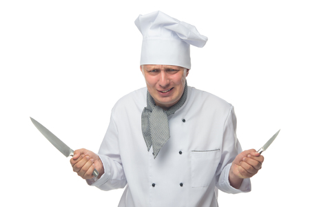 dissatisfied cook, holds 2 knives in his hands