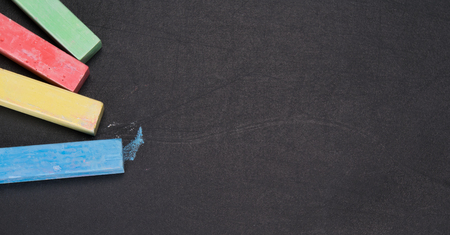 set of colored crayons, close-up, on black boardの写真素材
