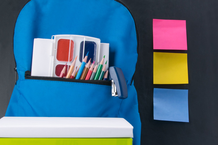 Items for creativity and a backpack on the background of a school board and stickers for your recordsの写真素材
