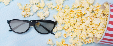scattered on a light gray background, popcorn in a bucket and 3 d glassesの写真素材