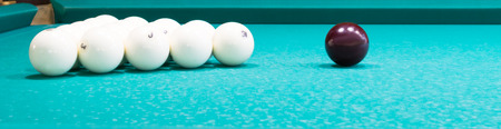 white balls for big billiards lie on a green cloth, a long photo
