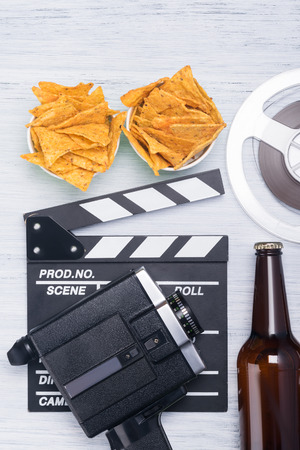 nachos, beer and equipment for shooting a film on a light backgroundの写真素材