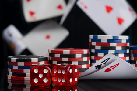 set for playing for money, two aces and dice on a black background, flying cards