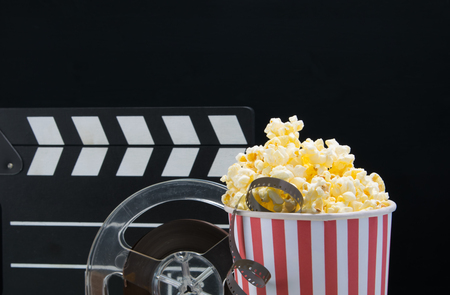 black background, a bucket of popcorn, film, double for filming, at the bar on the tableの写真素材