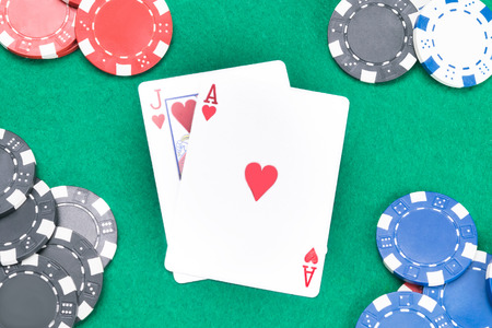 concept of cards and poker chips on a green table