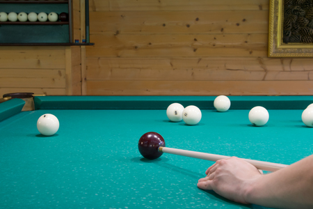 game of Russian Billiards, kick the ball cue on the green table