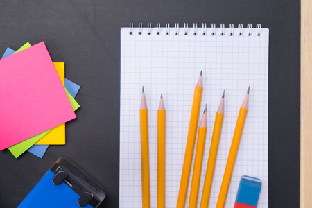 black background for writing, with a set of subjects for learning, stickers, white notebook, pencilsの写真素材