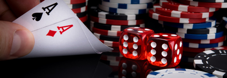 two playing red dice and cards on the background of stacks of poker chips