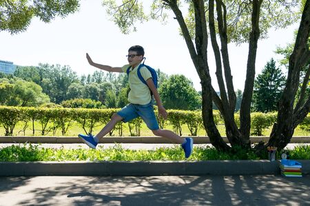 schoolboy jumped for joy in the park that the lessons endedの写真素材
