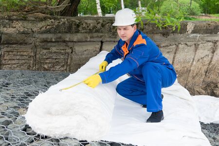 worker closes the stones with a white cloth to create an artificial pool