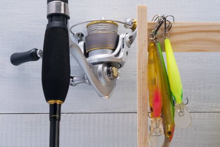 reel on a fishing rod and bait for fishing, close-up