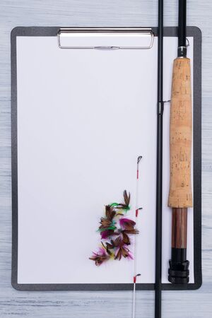 empty sheet of paper and tackle for fishing on it, a place for an inscriptionの写真素材