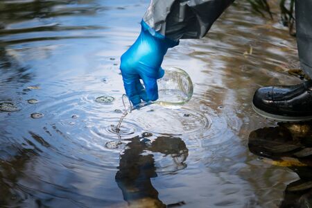 terrorist in protective clothing, treatment facilities, infects the water, pours out of the tube poisonsの写真素材