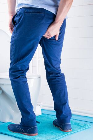 man came to the toilet, rear view, diarrhea