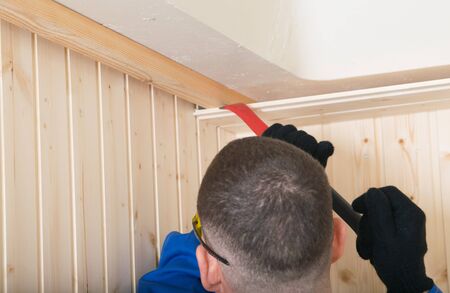 disassembly of the room by the master for dismantling, opening of the wooden ceiling covering